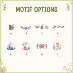 May include: Image with the text "MOTIF OPTIONS" above eight colorful beach-themed illustrations. The illustrations include a sailboat, seashells, a crab, a sandcastle, fish, a beach scene, a crab with seahorses, and a seahorse.
